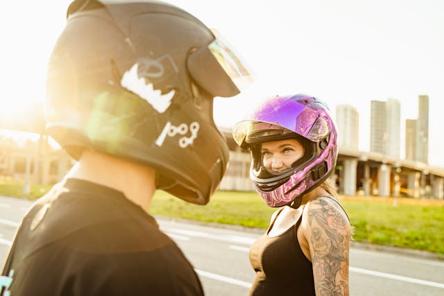 Two motorcyclists wearing helmets 