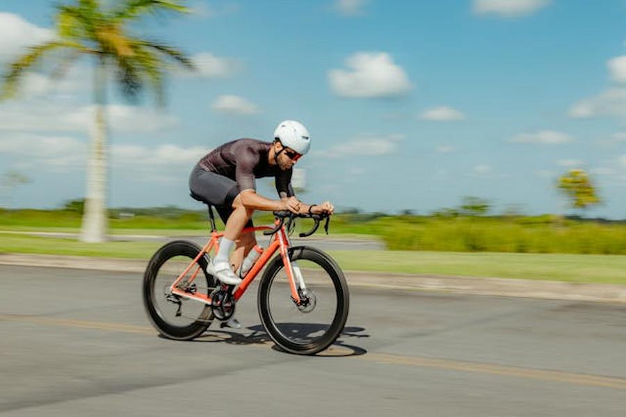 A man riding a bicycle wearing protective gear